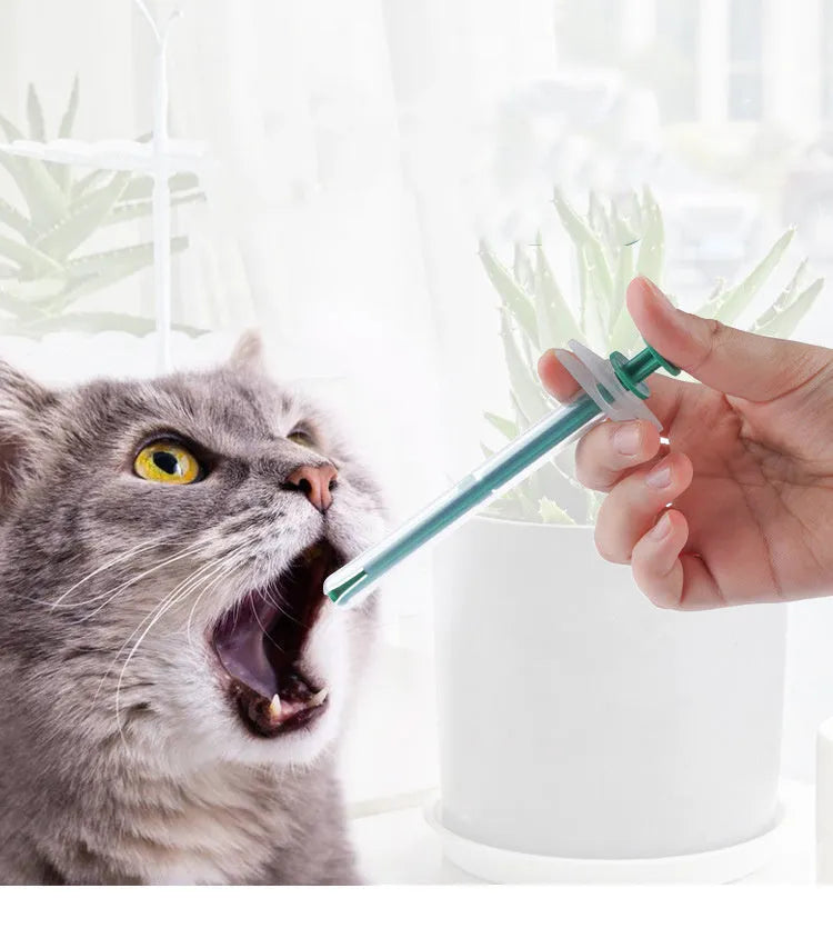 Two silicone pet pill shooters, one larger and one smaller, with soft tips and push rods.