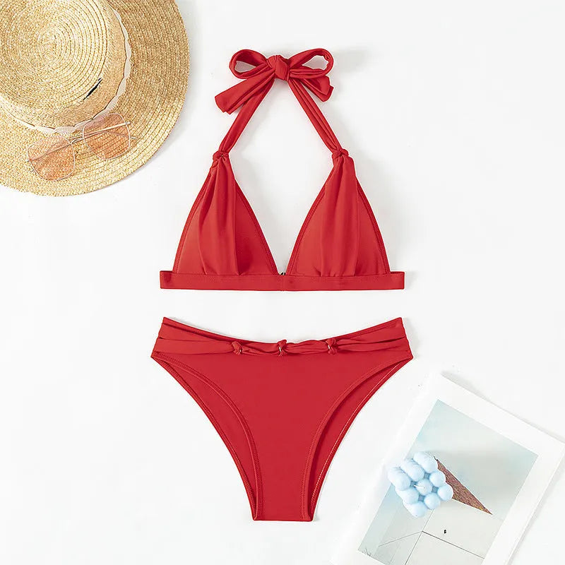 Red women's lace-up halterneck bikini set with split beach design for swimming