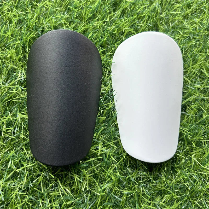 Extra small plastic football shin guards in black or white colour options