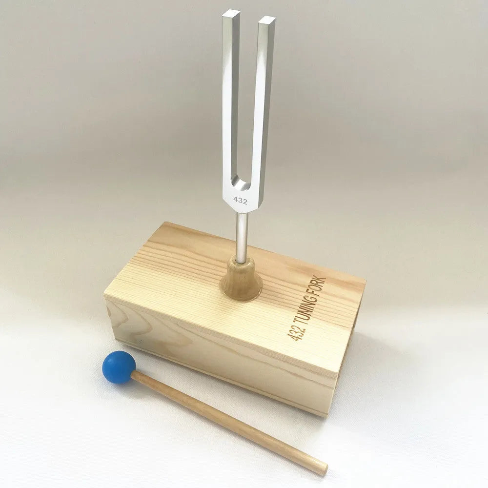 Aluminium alloy 432Hz tuning fork with speaker on kraft paper box background
