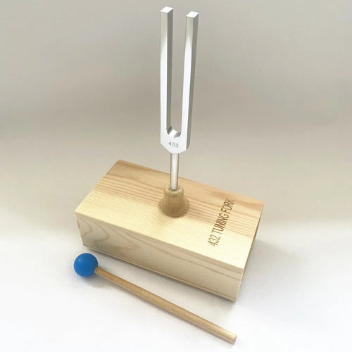 Aluminium alloy 432Hz tuning fork with speaker on kraft paper box background
