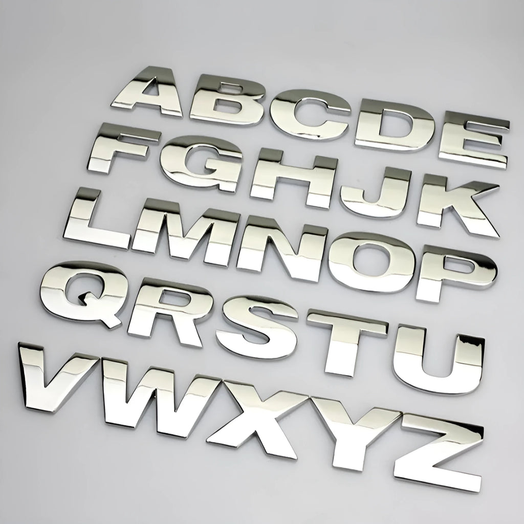 Close-up of a single 3D metal car letter sticker in zinc alloy on a vehicle bumper.