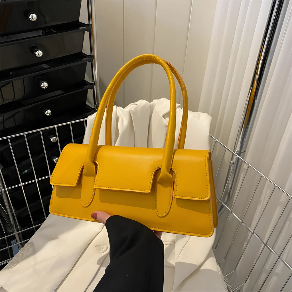 Women's retro style small square shoulder bag in four colours with adjustable strap and stitching detail