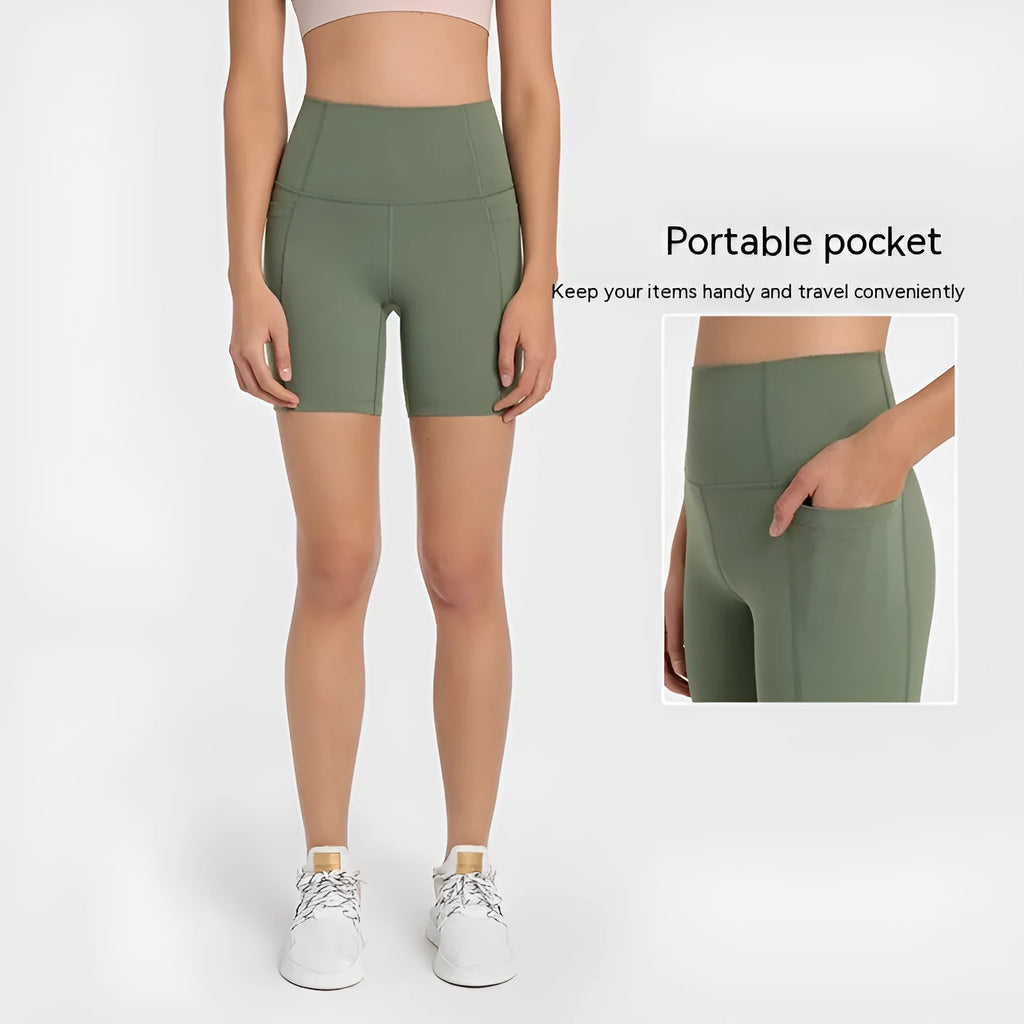 Women's tight-fit cotton blend sports shorts in short fifth pants length on a neutral background.