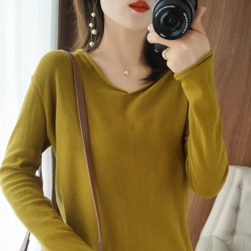 Women's V-neck long sleeve knitwear pullover top in a non-ironing material on a hanger.