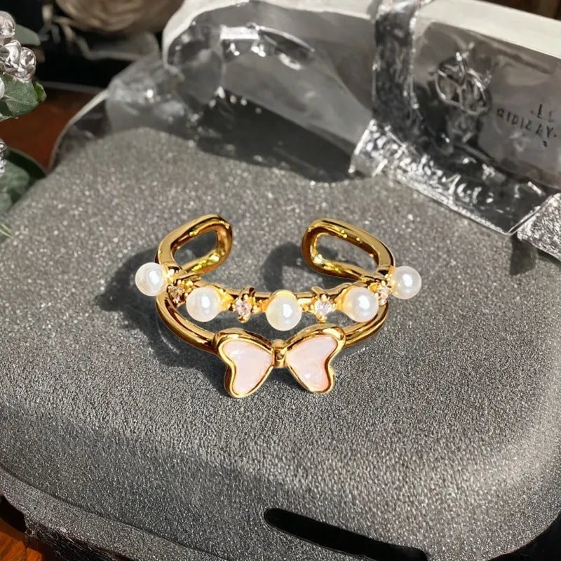 Adjustable copper women's ring with vintage oil drip finish, gourd shape, and inlaid zircon stones in floral and bow designs.