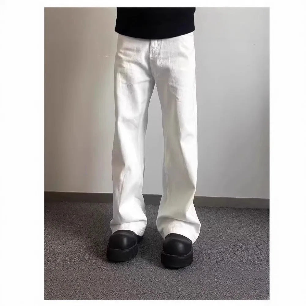 A pair of men's straight-leg white jeans with a mid-rise waist and zipper fly on a plain background.