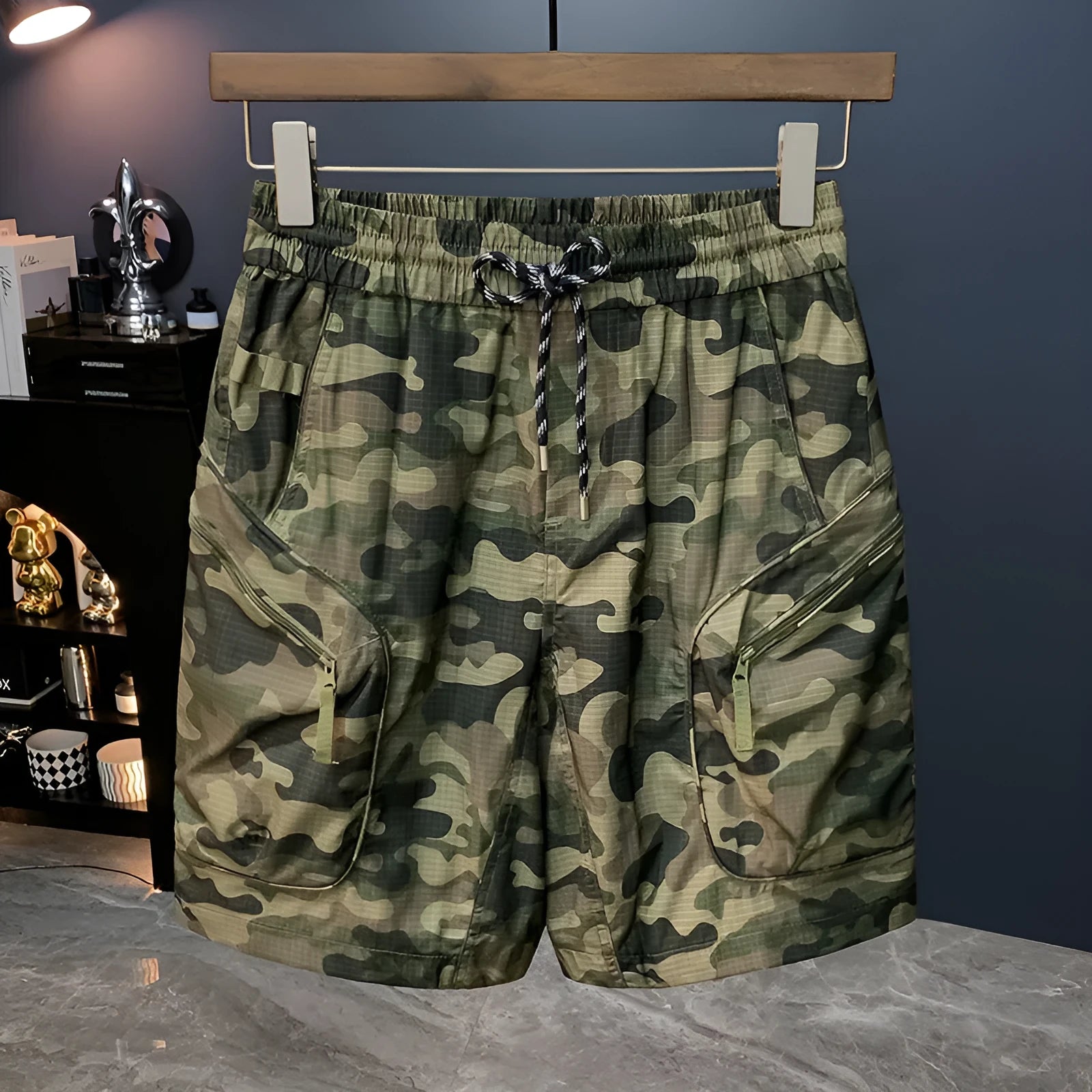 Men's camouflage pattern cargo shorts shown in loose knee-length fit on a mannequin
