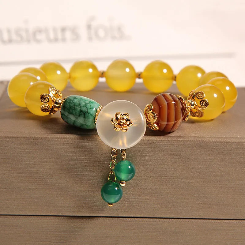 Khaki crystal bead bracelet on an adjustable gold silk cord.