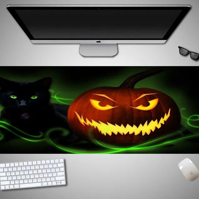 Oversized Halloween-themed gaming mouse pad with non-slip base on a desk.