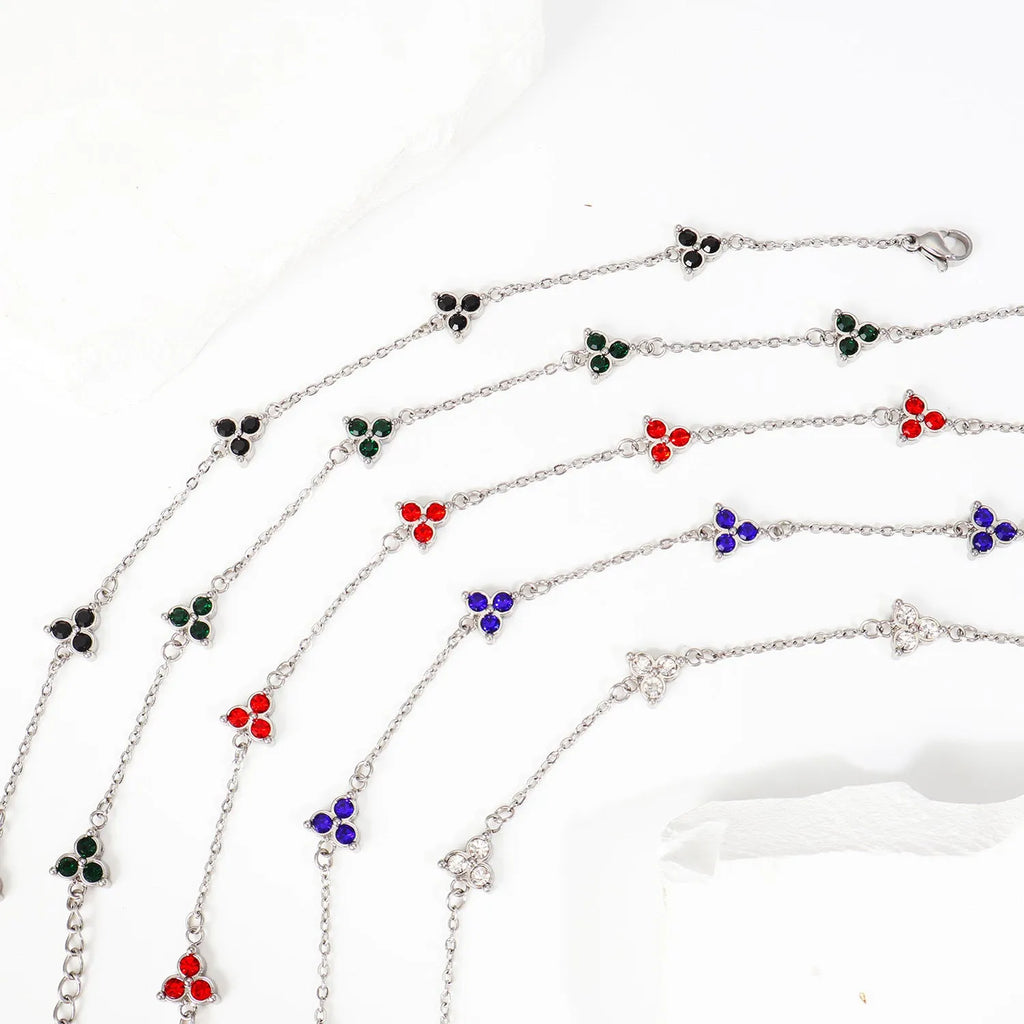 Geometric triangular stainless steel women's bracelet with coloured zircon stones in gold or steel finish.