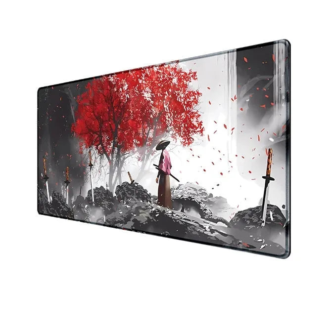Japanese samurai design gaming mouse pad with cloth surface on a desk.