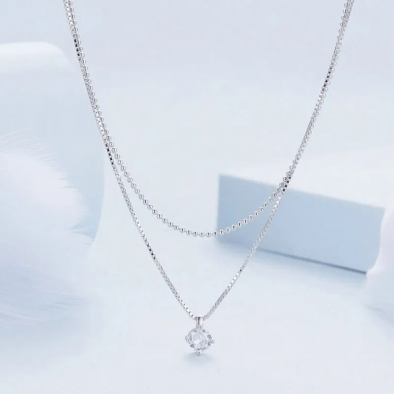Women's sterling silver double-layer necklace with pearl chain and contemporary pendant