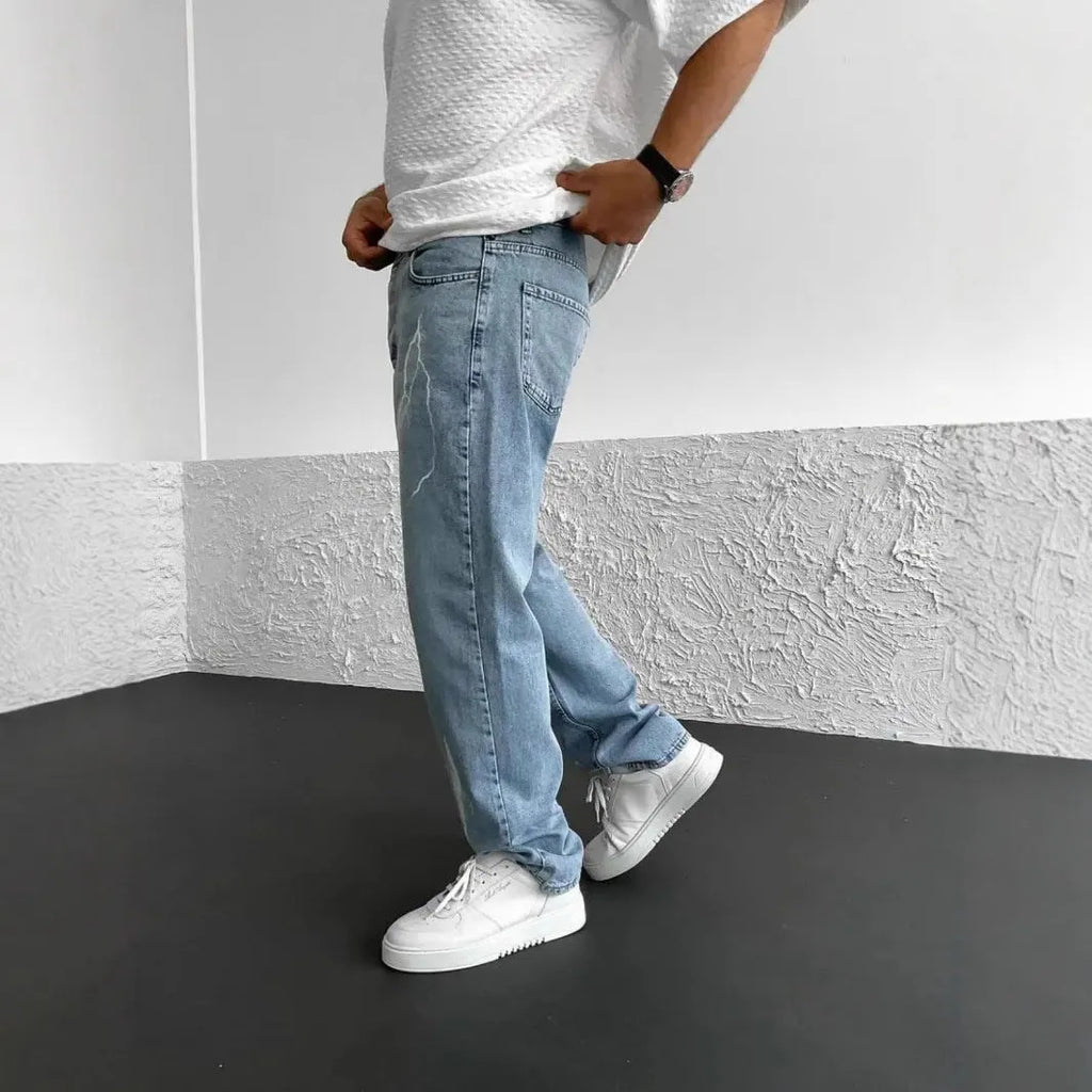 Men's blue straight-leg denim trousers with mid waist and zipper fly on neutral background