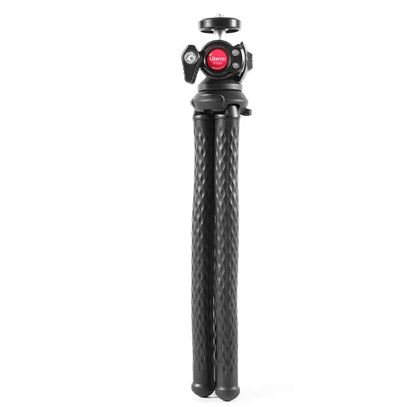 Black octopus leg mobile phone tripod with clip, extended to 360mm on a table.