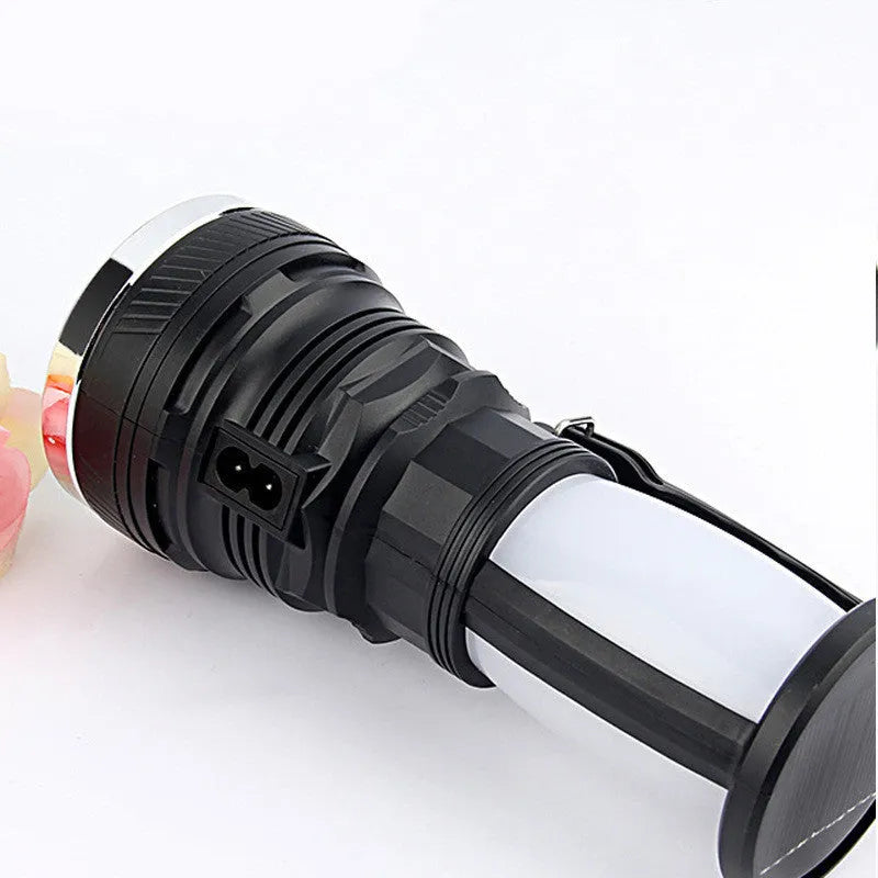 Black solar-powered LED emergency flashlight with USB charging port shown on a textured background.