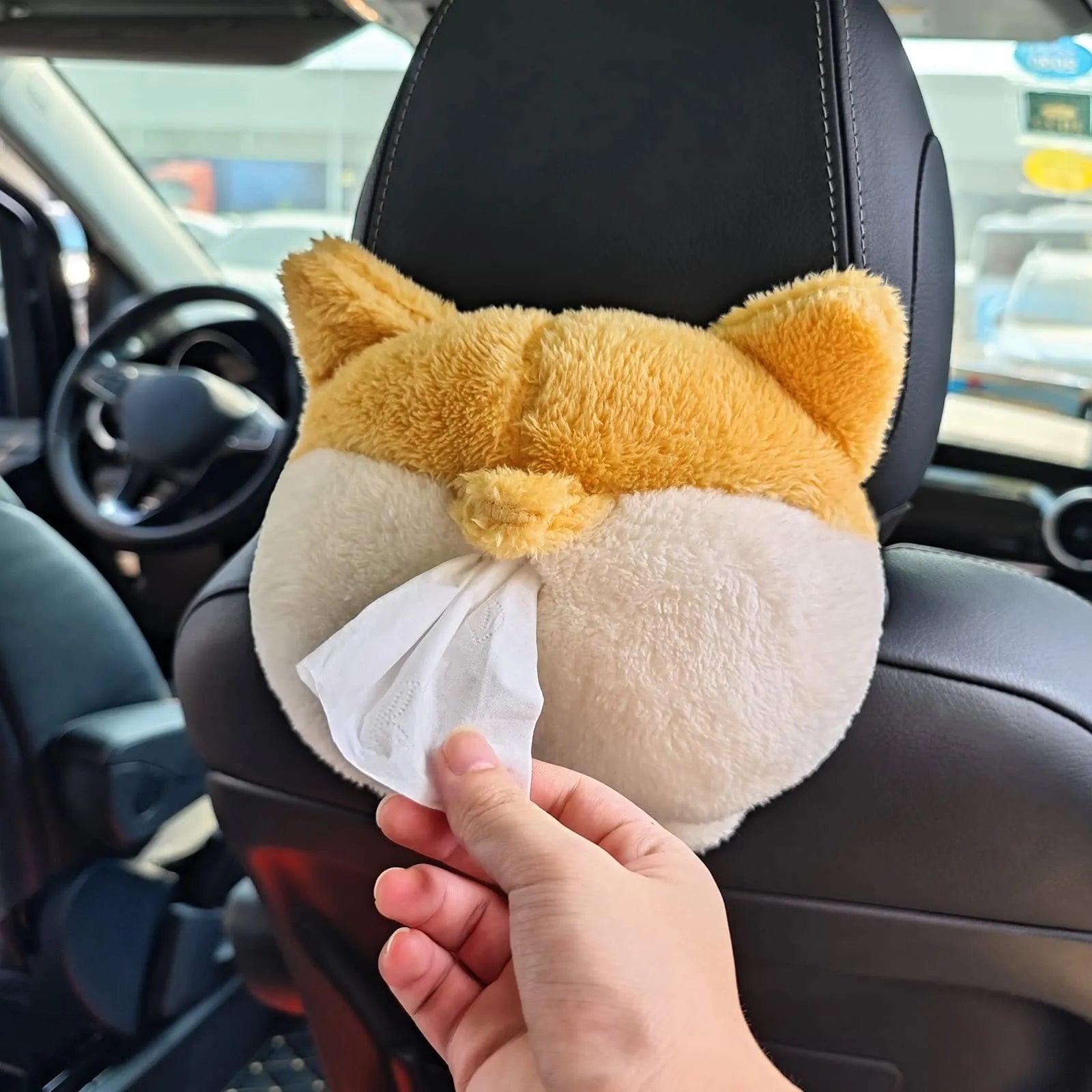 Yellow corgi butt shaped fabric pouch for holding a tissue box, shown with elastic strap for hanging.