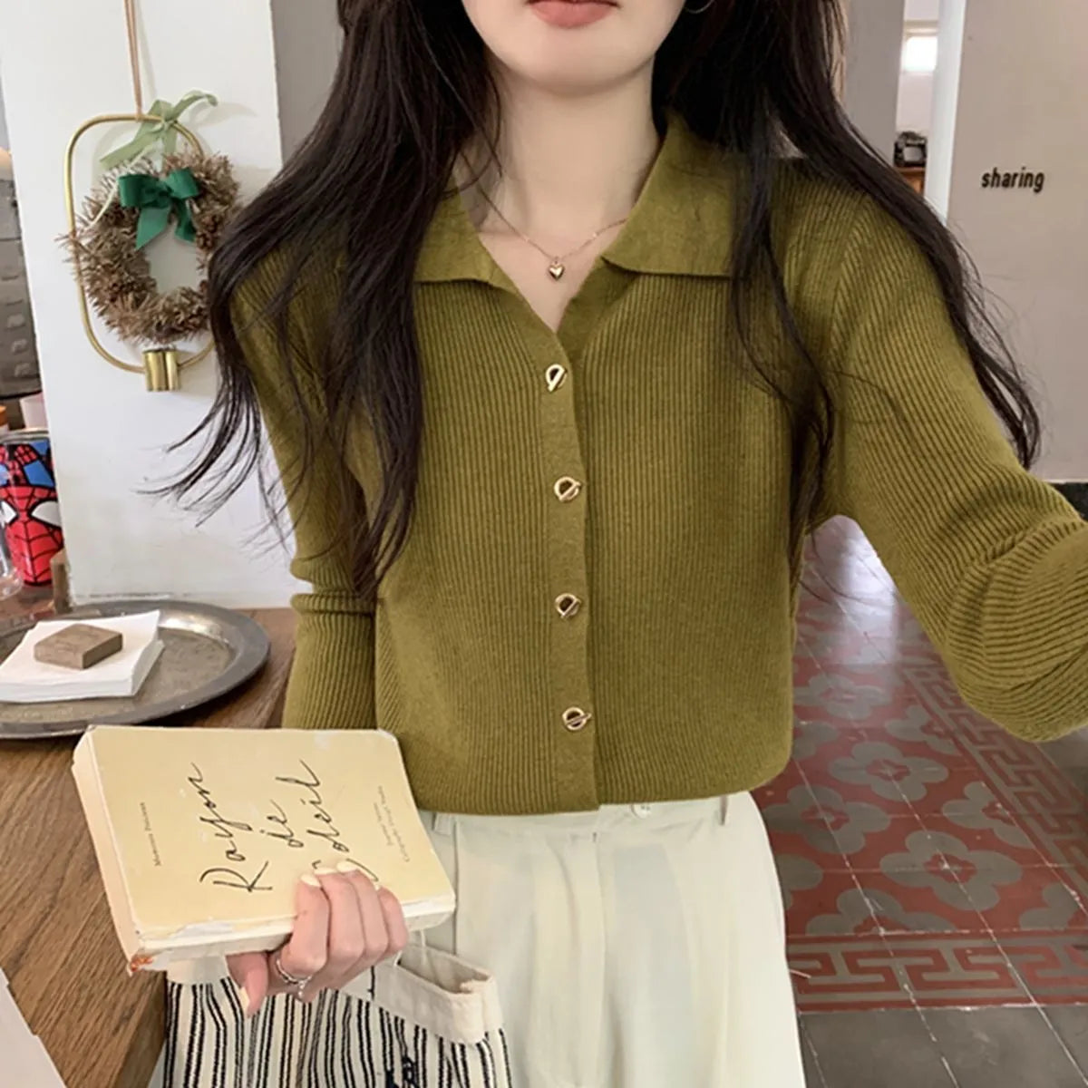 Beige loose fit long-sleeved viscose knitted cardigan top on a hanger.