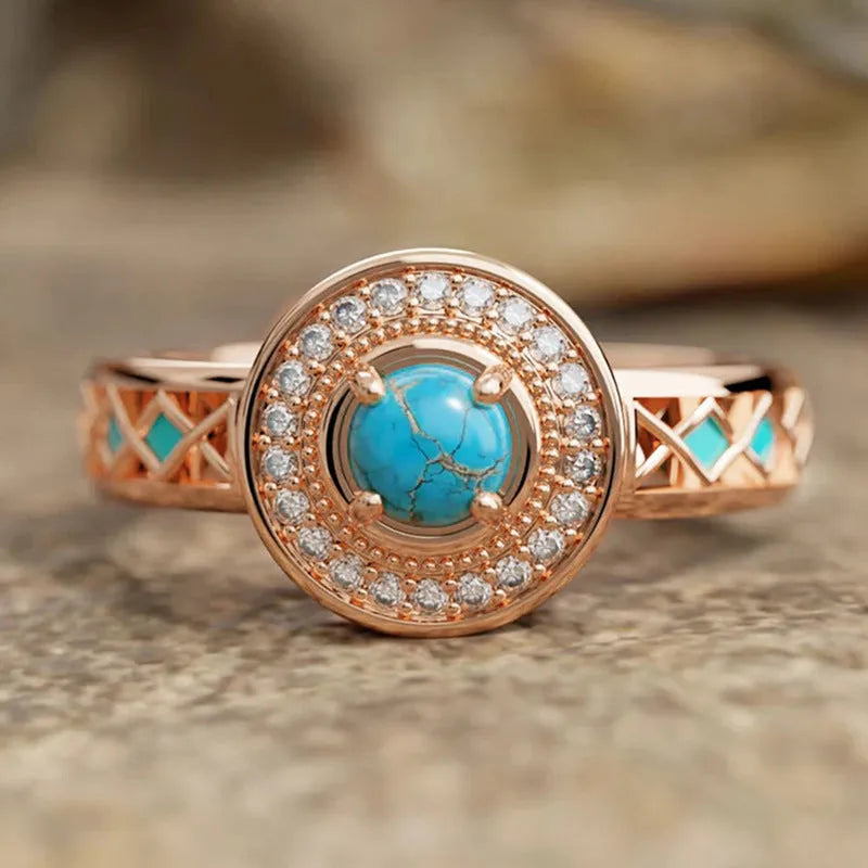 Rose gold geometric women's ring with turquoise inlaid zircon on a copper band.