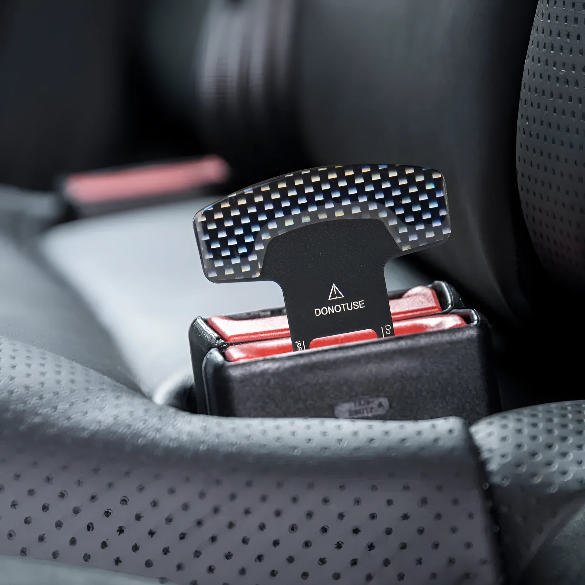 Aluminium alloy keychain with a 2.1 cm lock tongue buckle bottle opener in frosted carbon fibre finish.