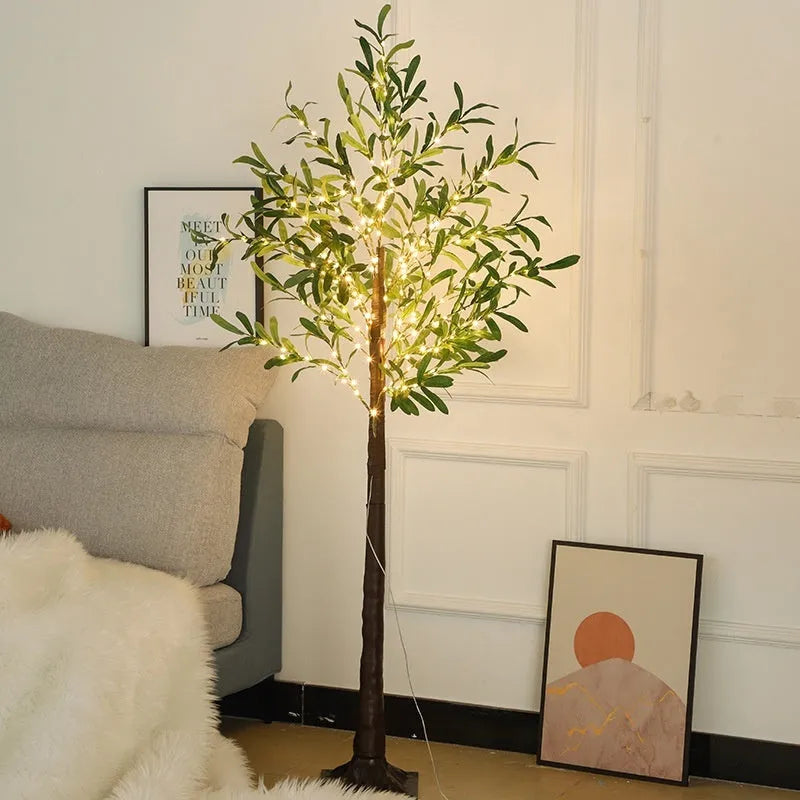 1.8 metre tall artificial olive tree lamp with warm LED lights illuminating courtyard decoration