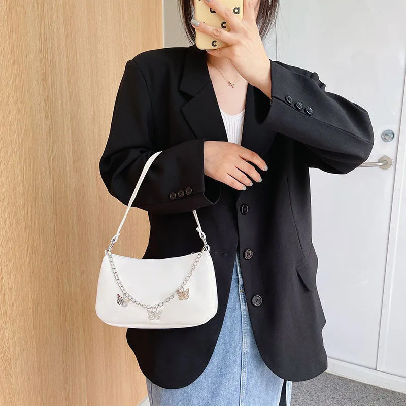 Horizontal square PU leather crossbody bag with butterfly chain detailing in light blue colour