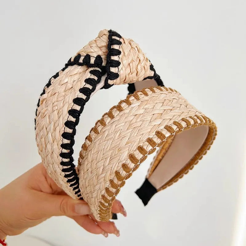 Bamboo woven wide brim hair band in black with bend and hitch details, side view on plain background