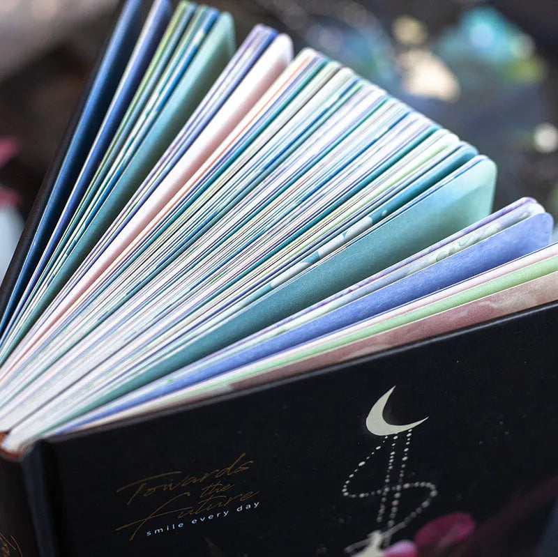 A5 notebook with luminous cover showing colour illustration pages inside, available in Deep Blue, Gold, Light Blue, or Purple colours