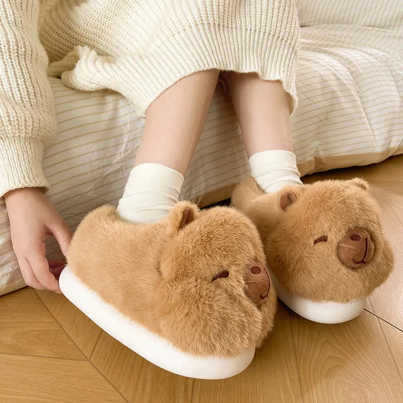 Light brown women's winter plush slippers with a cartoon pattern, round toe, and a pull-on oversleeve design.