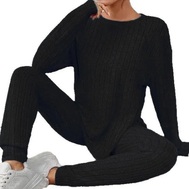 Women's black sunken stripe two-piece homewear set with a regular sleeve top and trousers.