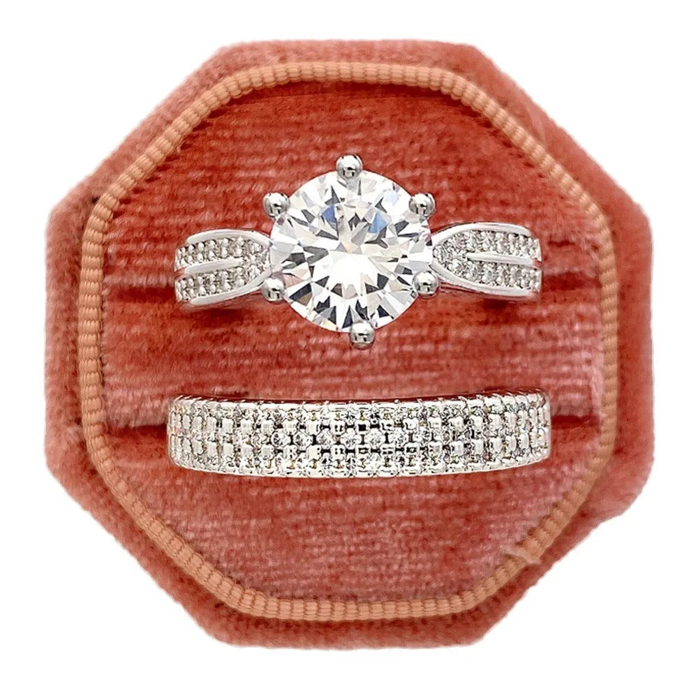 White gold colour geometric alloy ring bracelet with round design elements on a plain background.
