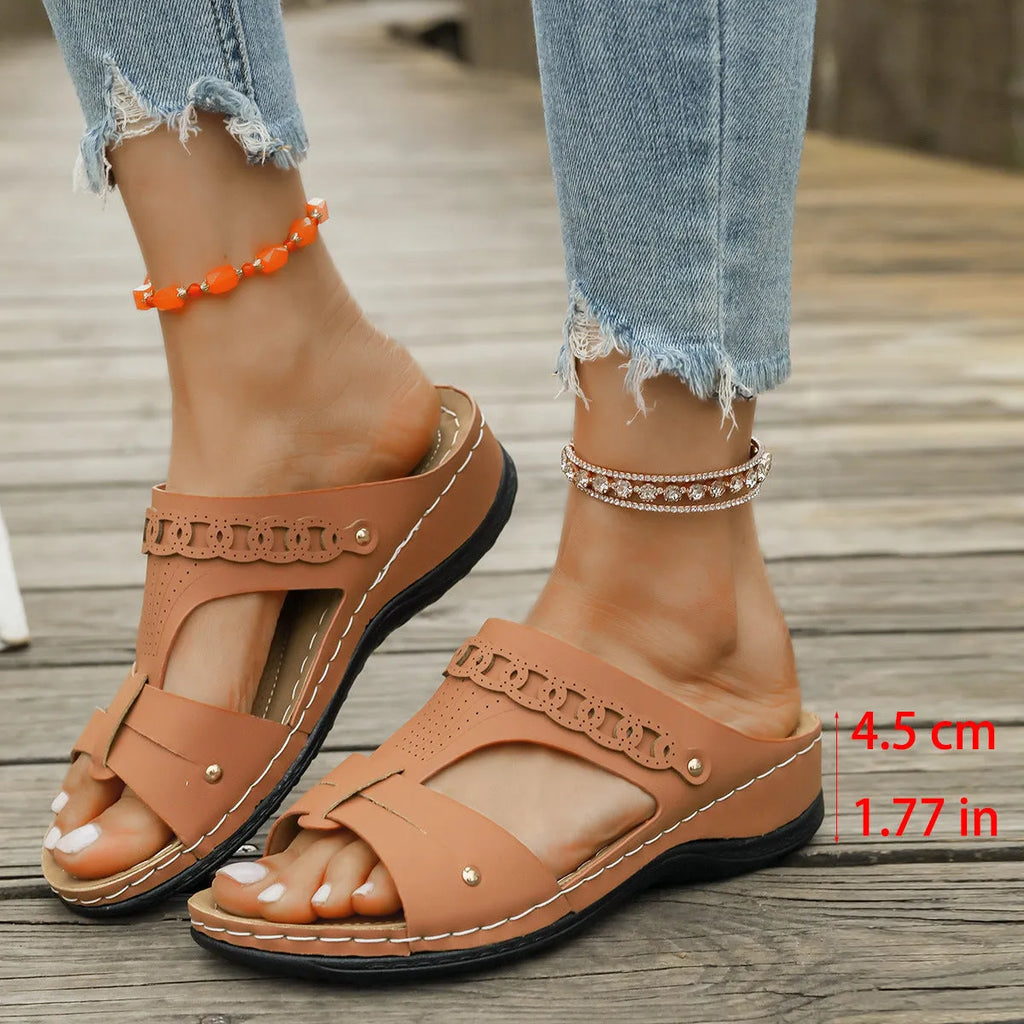 Slope heel roman style slippers with fish mouth toe holder in various colours on a rubber sole.