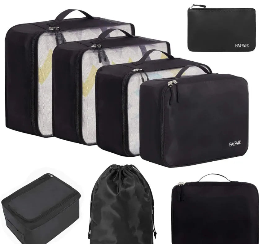 Set of eight cubic-shaped travel packing bags in assorted colours including beige, black, pink, and leopard print patterns.
