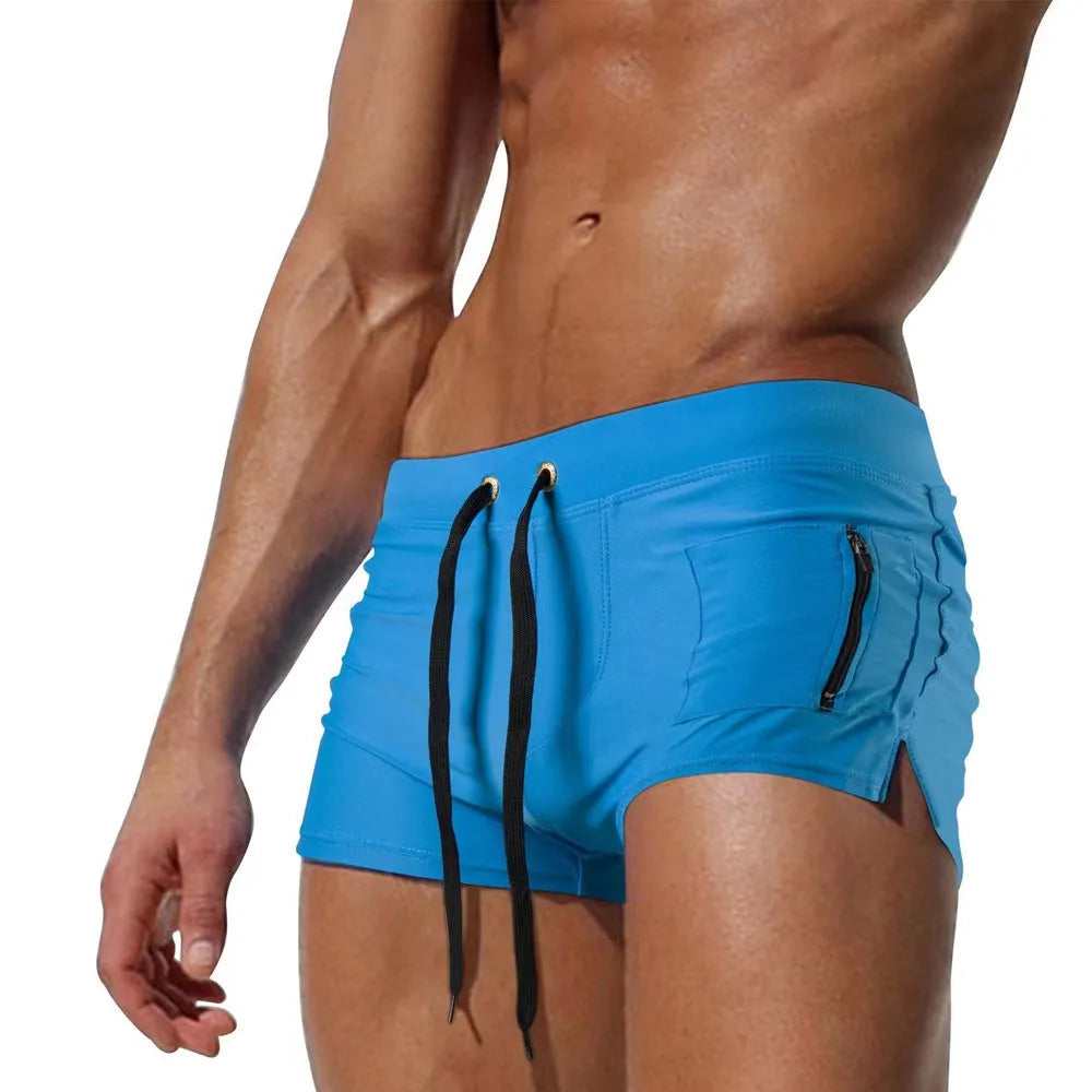 Men's black polyester swimming trunks with a high waist and lace-up front, shown in a briefs style.