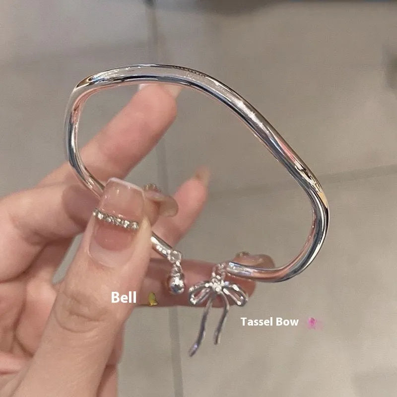 Silver bow adjustable bracelet with zinc alloy construction and electroplated finish.