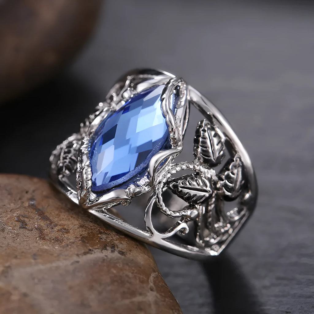 Blue crystal inlaid in a geometric horse eye shape on an alloy women's ring.