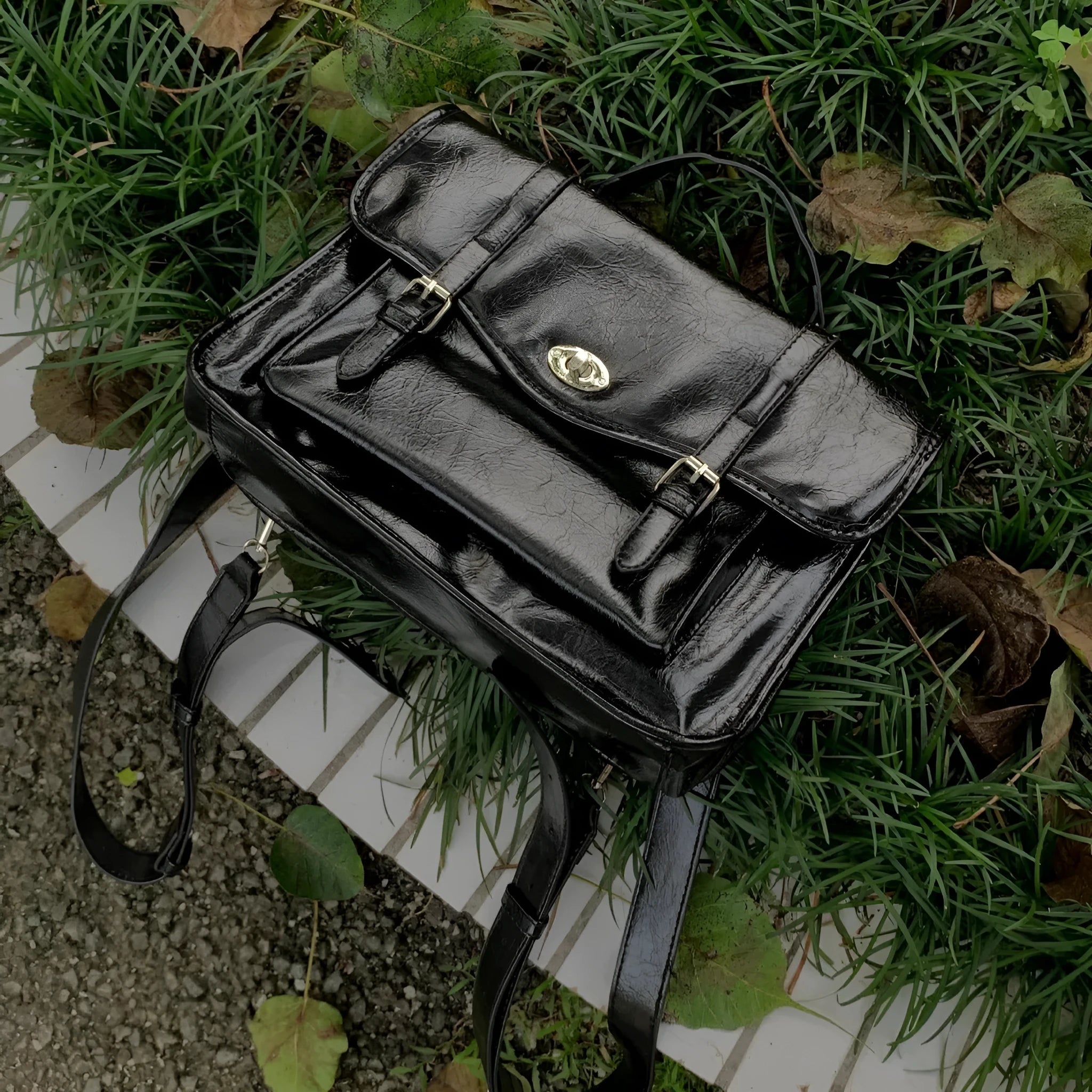 Black college style messenger bag with oil wax leather styling and adjustable strap