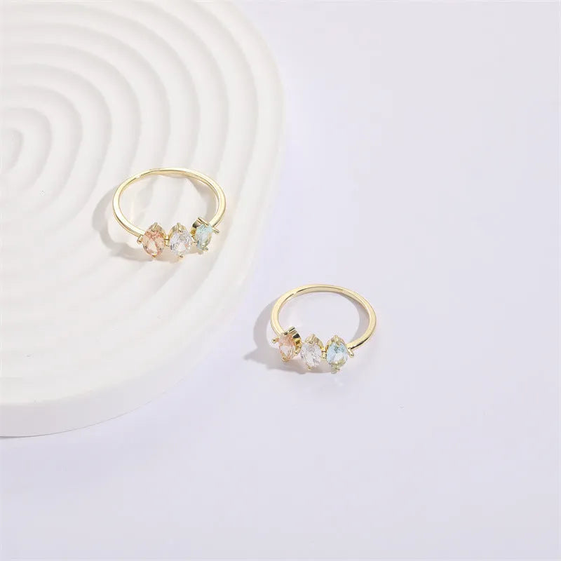 Geometric triangle ring with horse eye tricolor zircon in electroplated 14k gold colour on copper