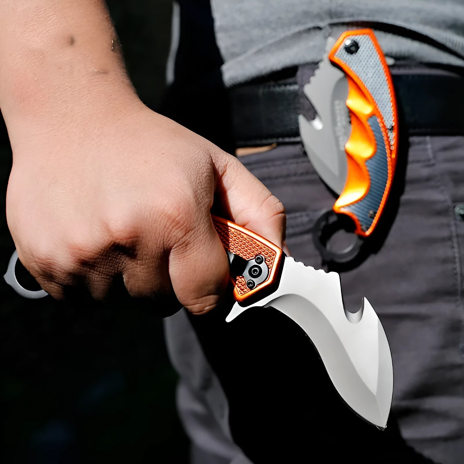 Orange folding knife with steel handle and 8.2cm blade open on outdoor surface showing total length and grip texture