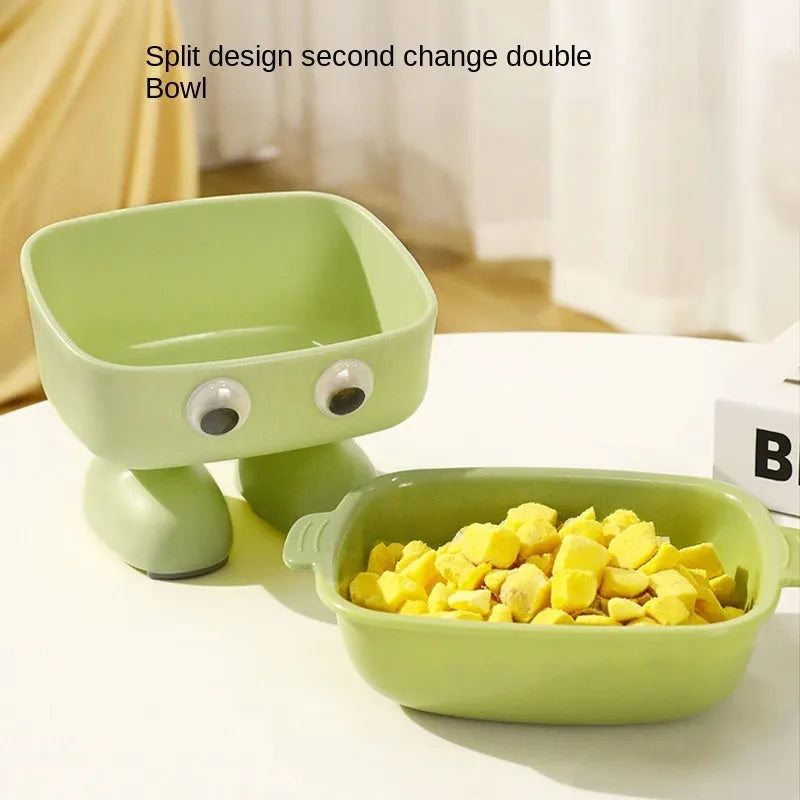 Green robot-shaped tilted cat bowl with detachable inner dish on a non-slip base.