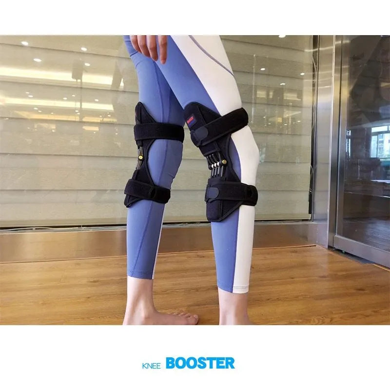 Black spring knee brace with adjustable straps on a grey background