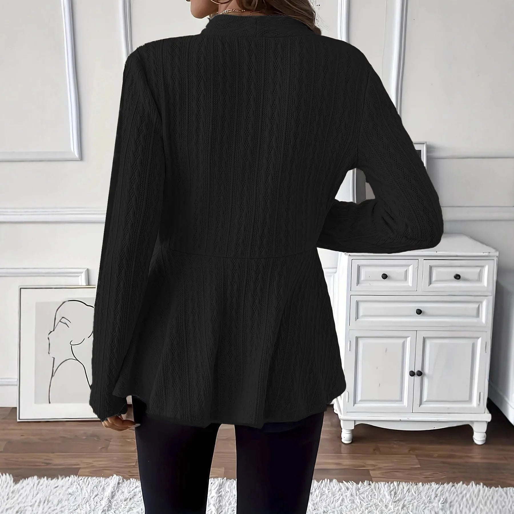 Women's apricot coloured Jacquard patterned knitted cardigan with one button, shown on a model.