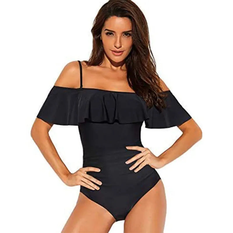 Black one-piece swimsuit with cut-out design and ruffled straps on the tube top.