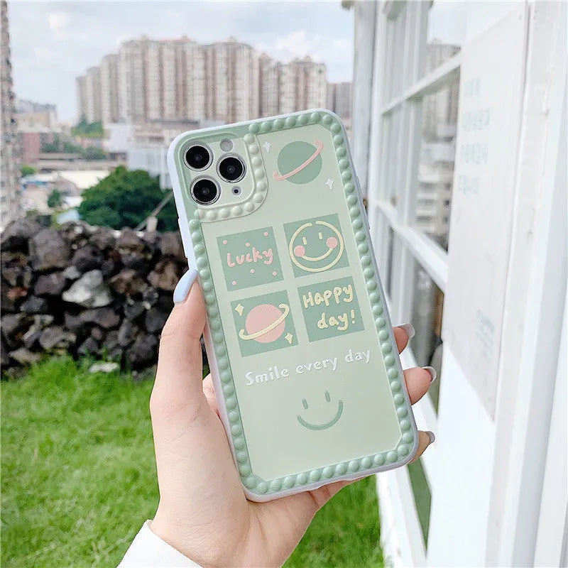 Green iPhone case with smiley face geometric patterns and polka dot frame designs