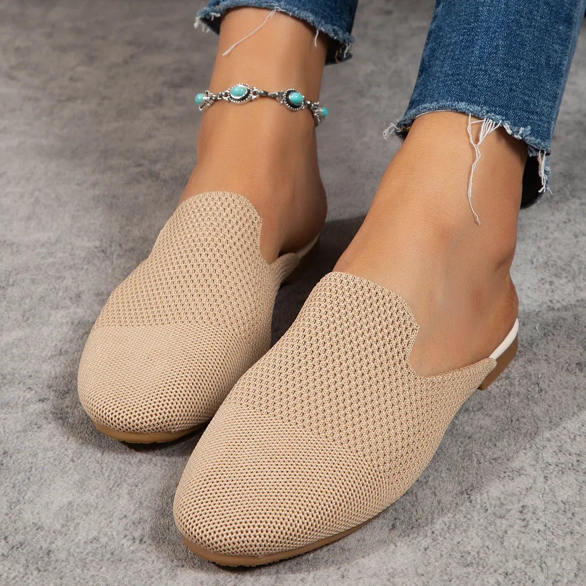 Pair of apricot-coloured mesh slip-on sandals with round toes and a flat rubber sole.