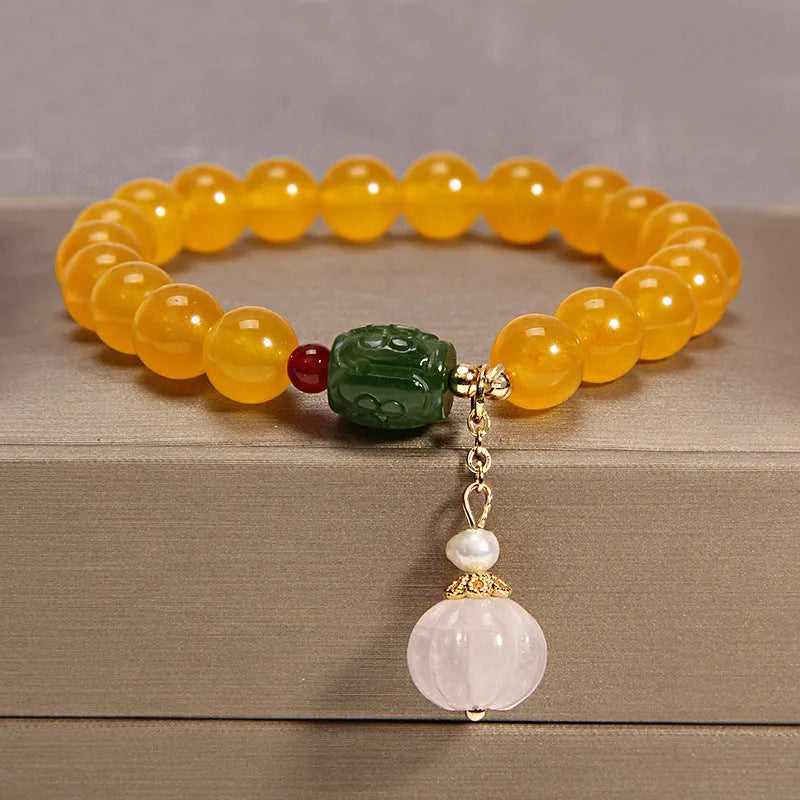 Khaki crystal bead bracelet on an adjustable gold silk cord.