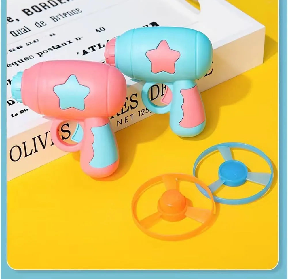 Blue or pink plastic cat toy gun launcher with spinning Frisbee for indoor cat play.