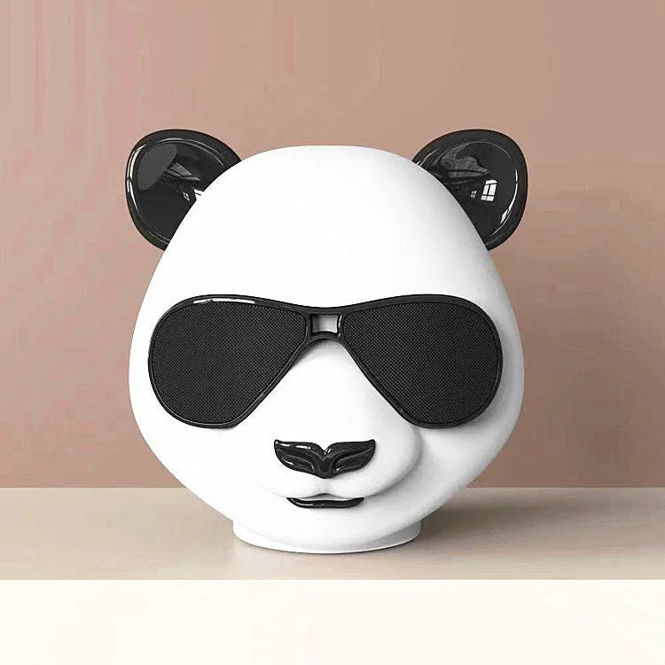 A portable classic style mini Bluetooth speaker on a table, showing its compact design.
