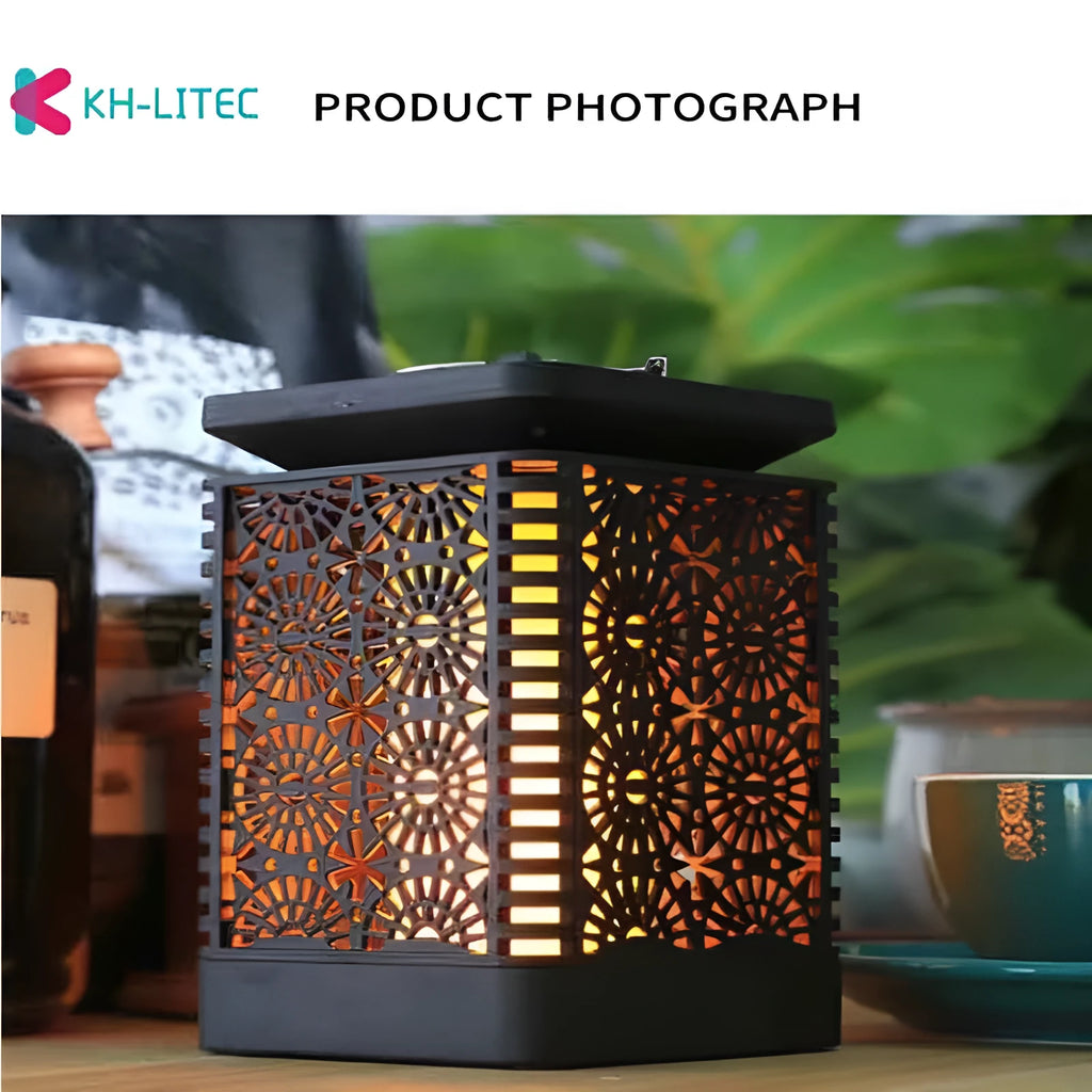 Set of four black solar-powered LED lanterns with flame flicker effect for outdoor garden use.