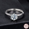 Simple classic 6 claw 1 karat moissanite ring in silver on white background, US size 7